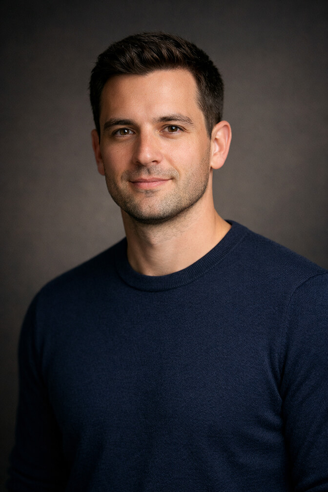 Professional headshot in a fitted navy crewneck sweater for tech industry