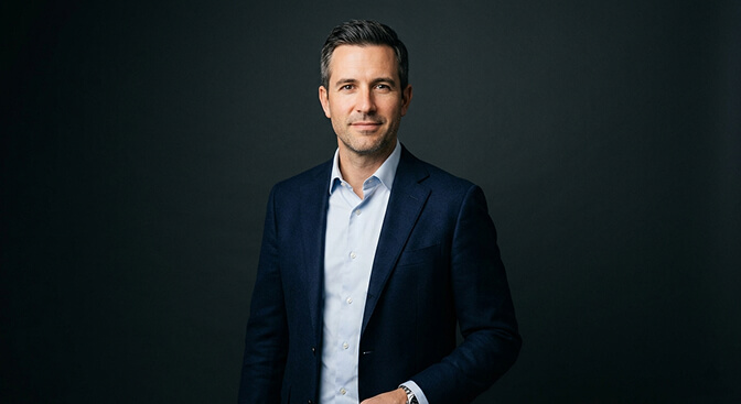 Example of the confident neutral corporate headshot style with dark background composed expression and structured clothing