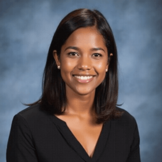 AI generated yearbook headshot of a young woman with blue gradient backdrop.