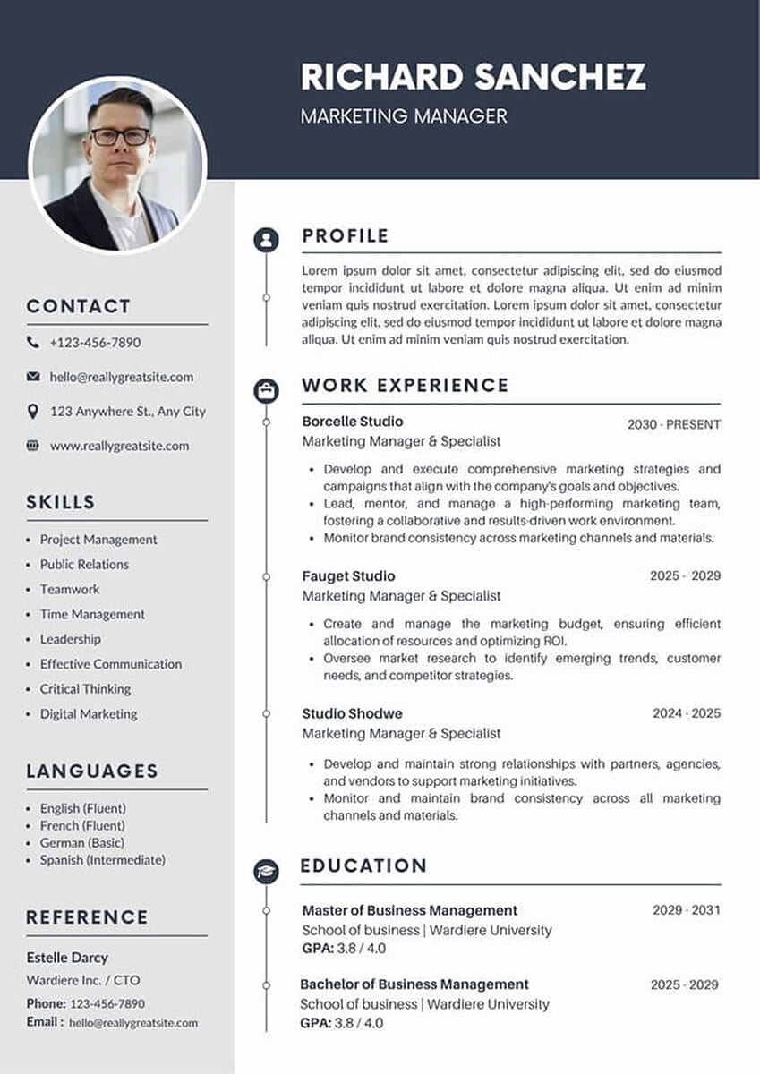 ATS-friendly CV photo example: a small circular headshot of a man in glasses and a dark jacket tucked into the top-left corner of a light grey sidebar, with a navy name banner and a clearly structured profile, work experience, and education section in the main column.