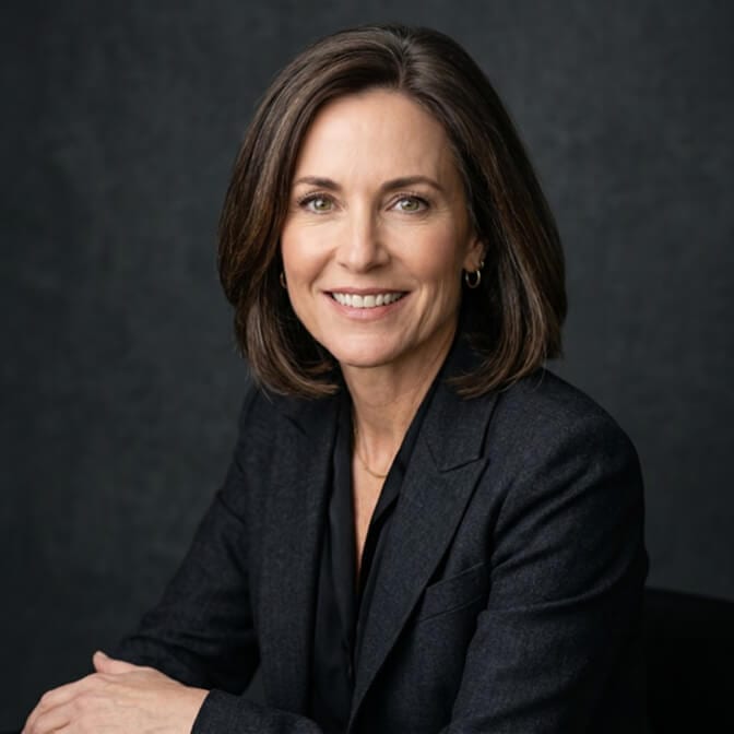 Confident, relaxed headshot of a senior professional woman with open posture and a warm expression