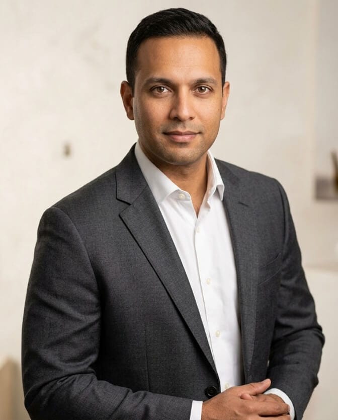Professional headshot of a man in a charcoal blazer, the kind of updated photo to use across LinkedIn and vendor introductions during engagement
