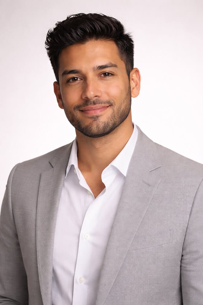 Professional AI headshot of a young man in a light gray blazer and white shirt against a clean white background