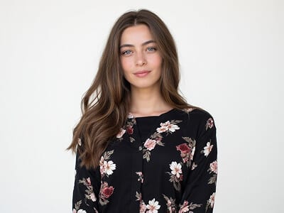 What not to wear for a passport photo: woman in a busy black floral print blouse, a pattern that interferes with automated facial checks