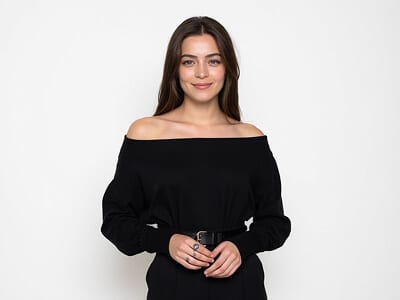 What not to wear for a passport photo: woman in an off-the-shoulder black top, a neckline that can look like bare skin once the photo is cropped