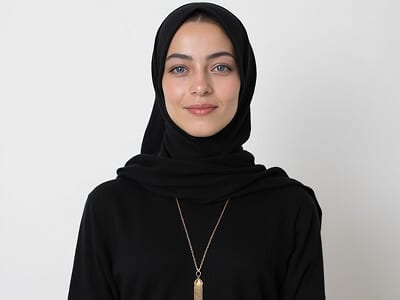 Passport photo with a religious head covering: woman in a black hijab against a plain background, with the full face visible from chin to forehead