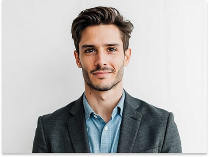 Charcoal passport photo outfit example for a man: charcoal blazer over a mid-blue collared shirt against a plain white background