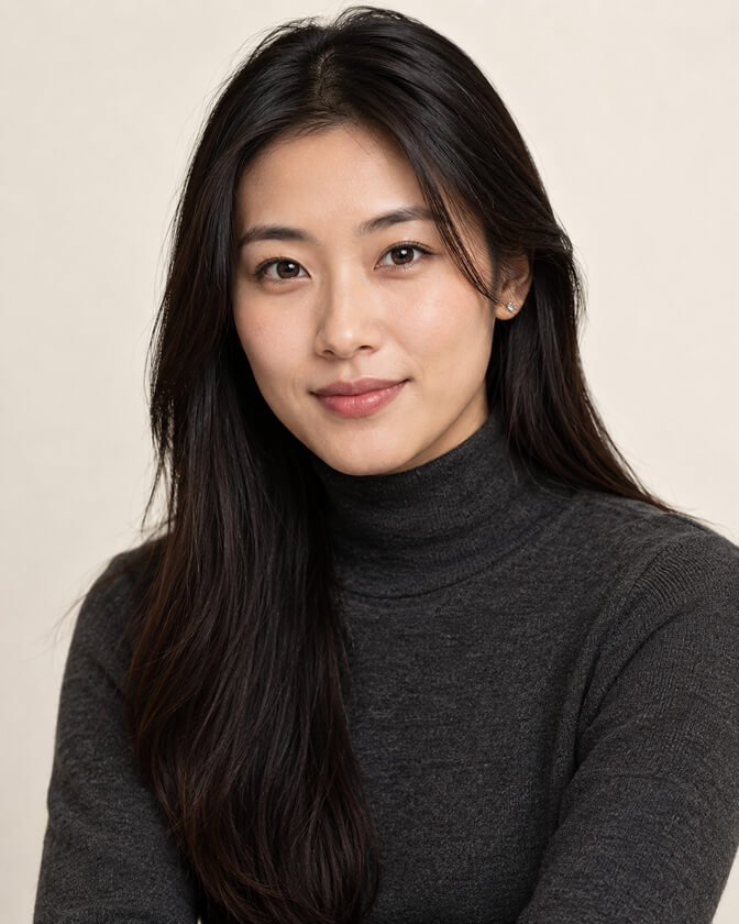 AI headshot of a smiling woman with long straight dark hair in a charcoal turtleneck sweater, photographed against a warm beige backdrop with soft frontal lighting.
