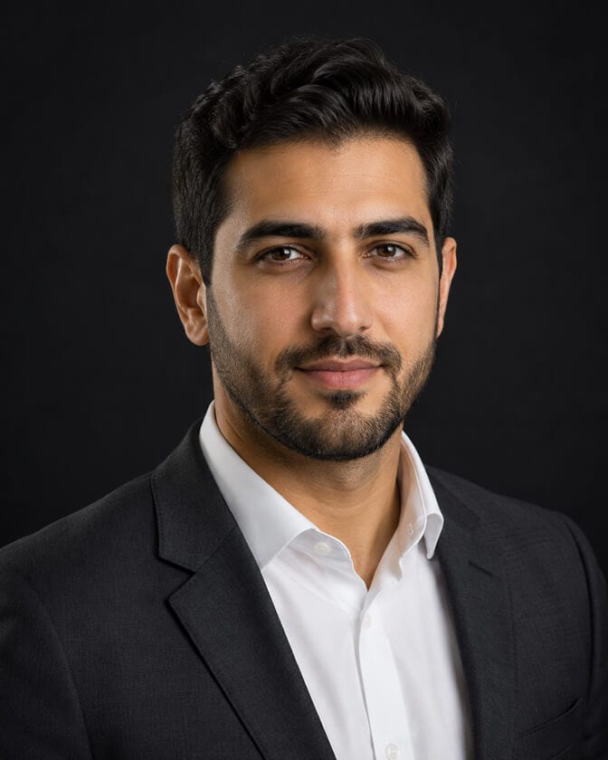 Professional AI headshot of a bearded man in a dark suit against a dark background, the same quality available on entry-level plans