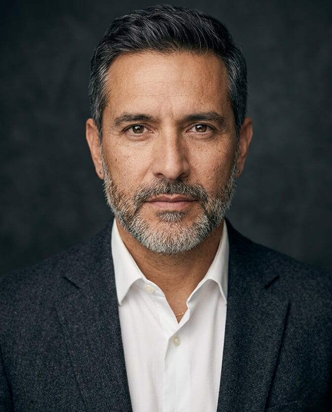 Before and after leadership team headshot grid showing the over smoothed first batch alongside the authentic minimally retouched second batch with natural skin texture preserved