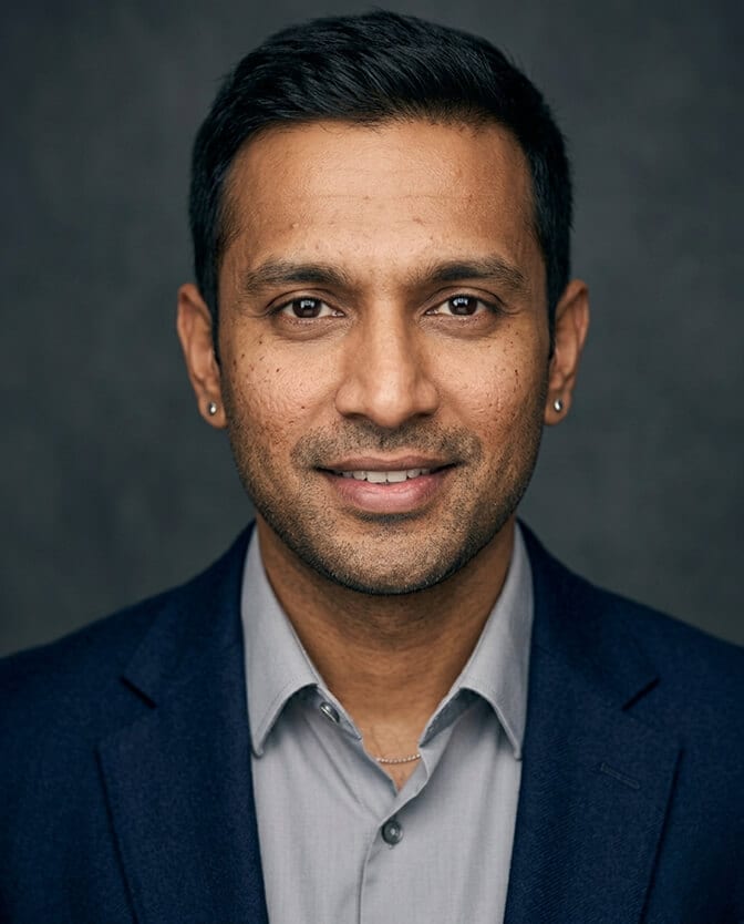 Close up detail of a quality AI headshot at 100 percent zoom showing visible pores, natural micro variation in skin tone, and preserved character lines around the eyes