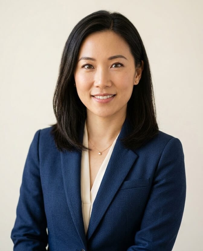 Polished headshot of a woman with eye contact, clean lighting, and a simple background, the controllable levers of the halo effect