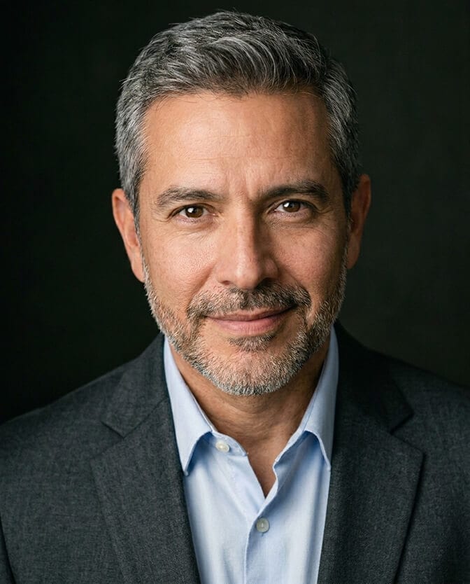 Professional iPhone style headshot of a man in a blue shirt against a clean softly blurred background showing the polished studio grade result of running the full pro settings checklist
