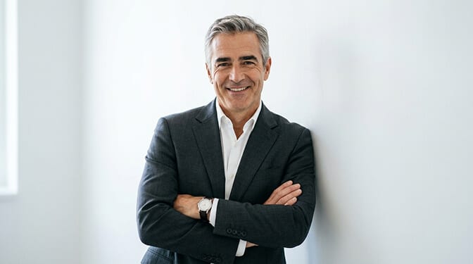 Relaxed leadership headshot pose with angled body natural lean and confident approachable expression
