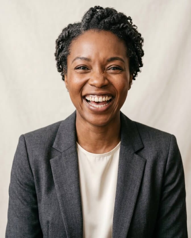 Woman laughing naturally in a headshot, showing the genuine expression that makes a photo feel like you