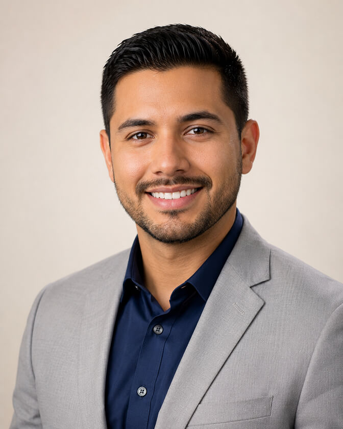 Professional AI headshot of a man in a light gray blazer and navy shirt against a soft warm background showing the natural confident look that emerges when the light, distance, and frame are right