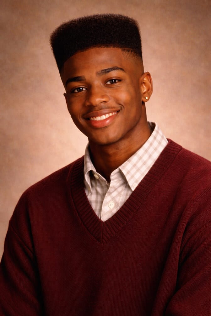 AI-generated 90s yearbook portrait of a young man in a sweater against a vintage studio backdrop