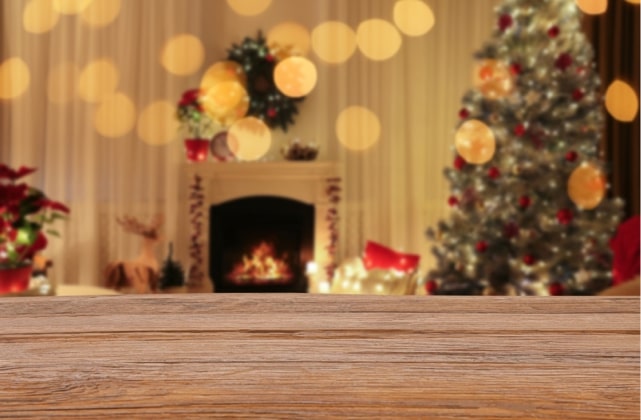 Festive Christmas background with decorated tree, warm fireplace, and cozy holiday lighting